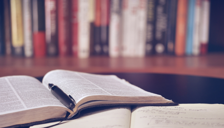 Photo: books laid out for studying in a library