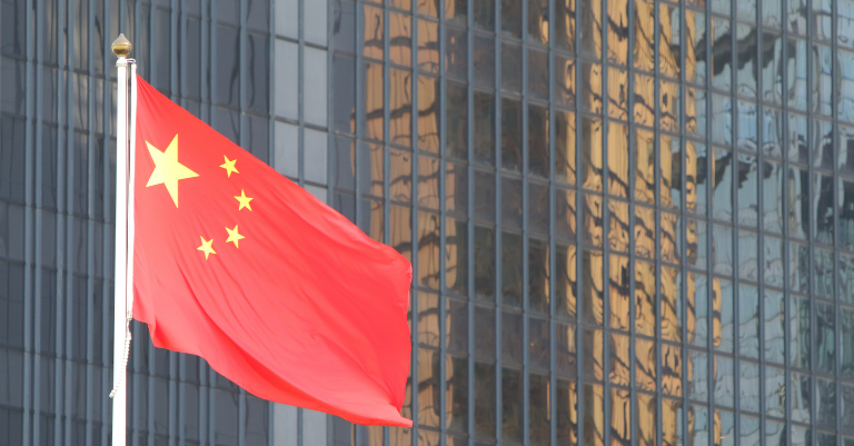Photo of Chinese flag in front of office buildings