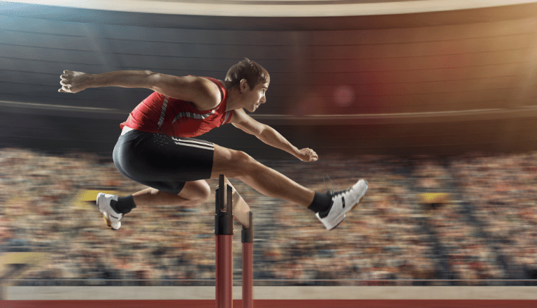 Photo: Man jumping over a hurdle